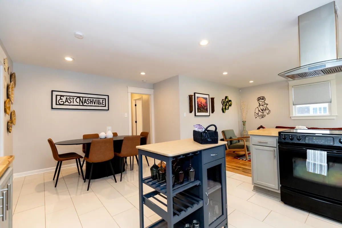 A sunlit dining area adjacent to a chef’s kitchen, complete with a large table, kitchen appliances, and welcoming decor. The space is perfect for shared breakfasts before heading out or regrouping for dinner after a day of adventures.